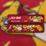 Charmander fiery orange woven fabric keytag attached to metal keyring featuring embroidered Charmander artwork