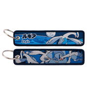 Back side view of Lugia embroidered keytag showing detailed stitching and fabric border