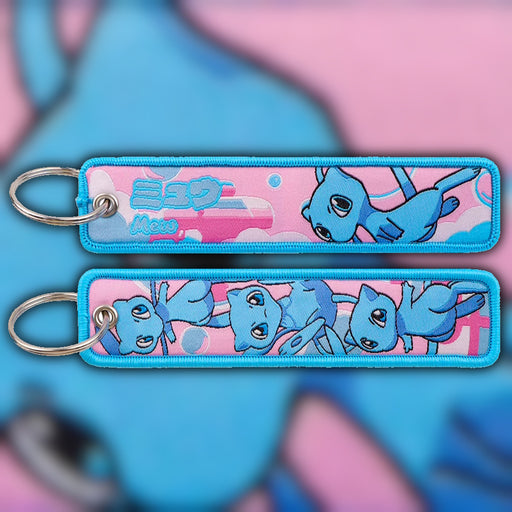 Main Image: Shiny Mew blue woven fabric keytag attached to metal keyring featuring embroidered Shiny Mew artwork