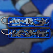 Umbreon black woven fabric keytag attached to metal keyring featuring embroidered Umbreon artwork