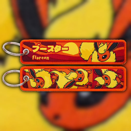 Flareon fiery orange woven fabric keytag attached to metal keyring featuring embroidered Flareon artwork
