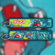 Totodile blue woven fabric keytag attached to metal keyring featuring embroidered Totodile artwork
