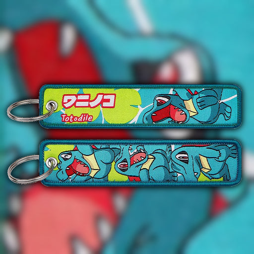 Totodile blue woven fabric keytag attached to metal keyring featuring embroidered Totodile artwork